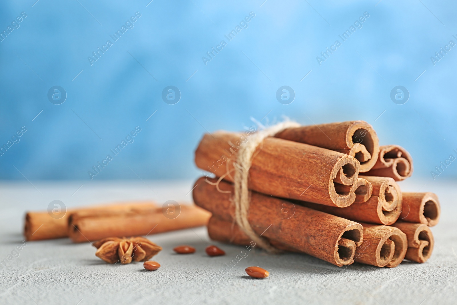 Photo of Tied cinnamon sticks on table, closeup