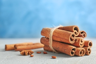 Photo of Tied cinnamon sticks on table, closeup