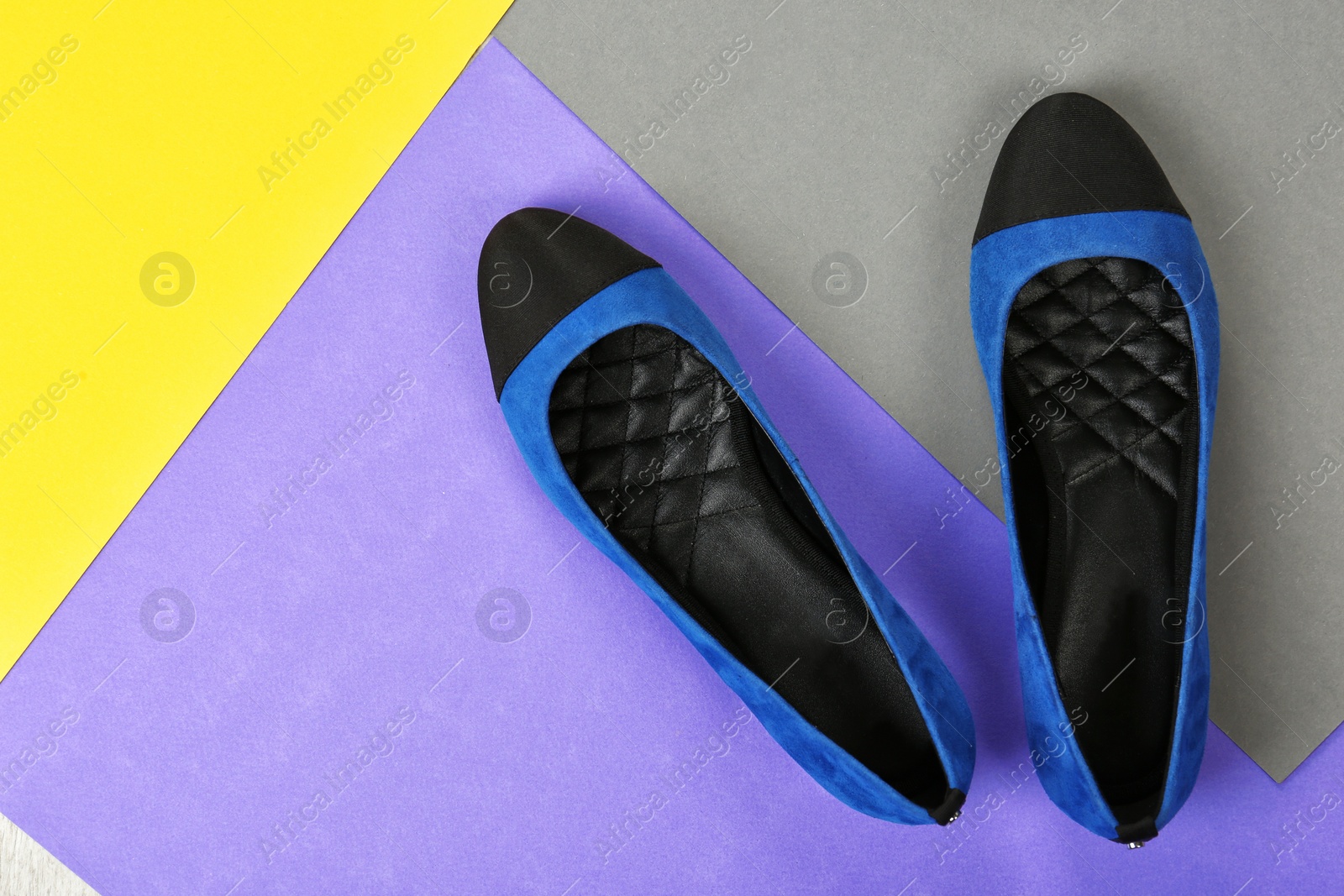 Photo of Pair of female shoes on color background, top view