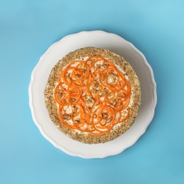 Photo of Dish with delicious carrot cake on color background, top view