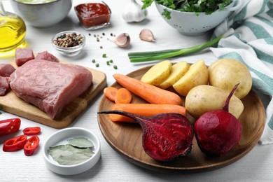 Photo of Fresh ingredients for borscht on white wooden table