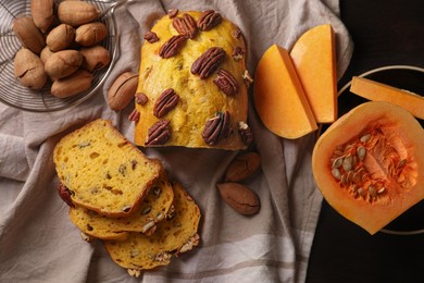 Delicious pumpkin bread with pecan nuts on table, flat lay