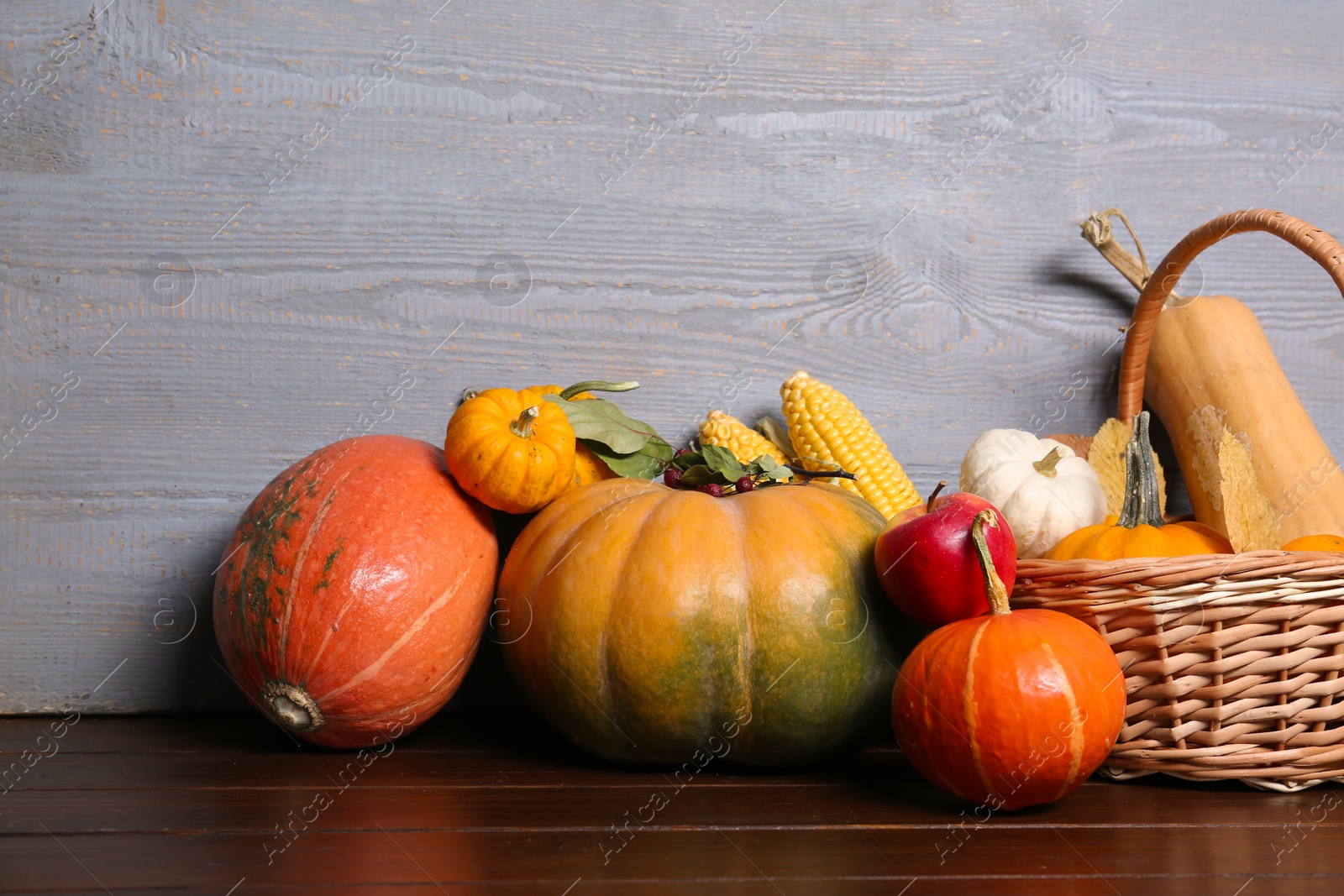 Photo of Happy Thanksgiving day. Beautiful composition with pumpkins on wooden table