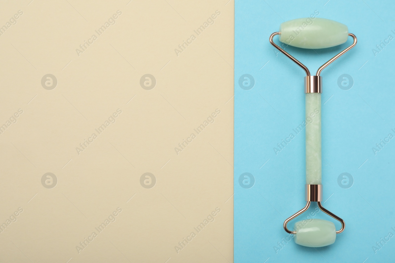 Photo of Natural face roller on color background, top view. Space for text