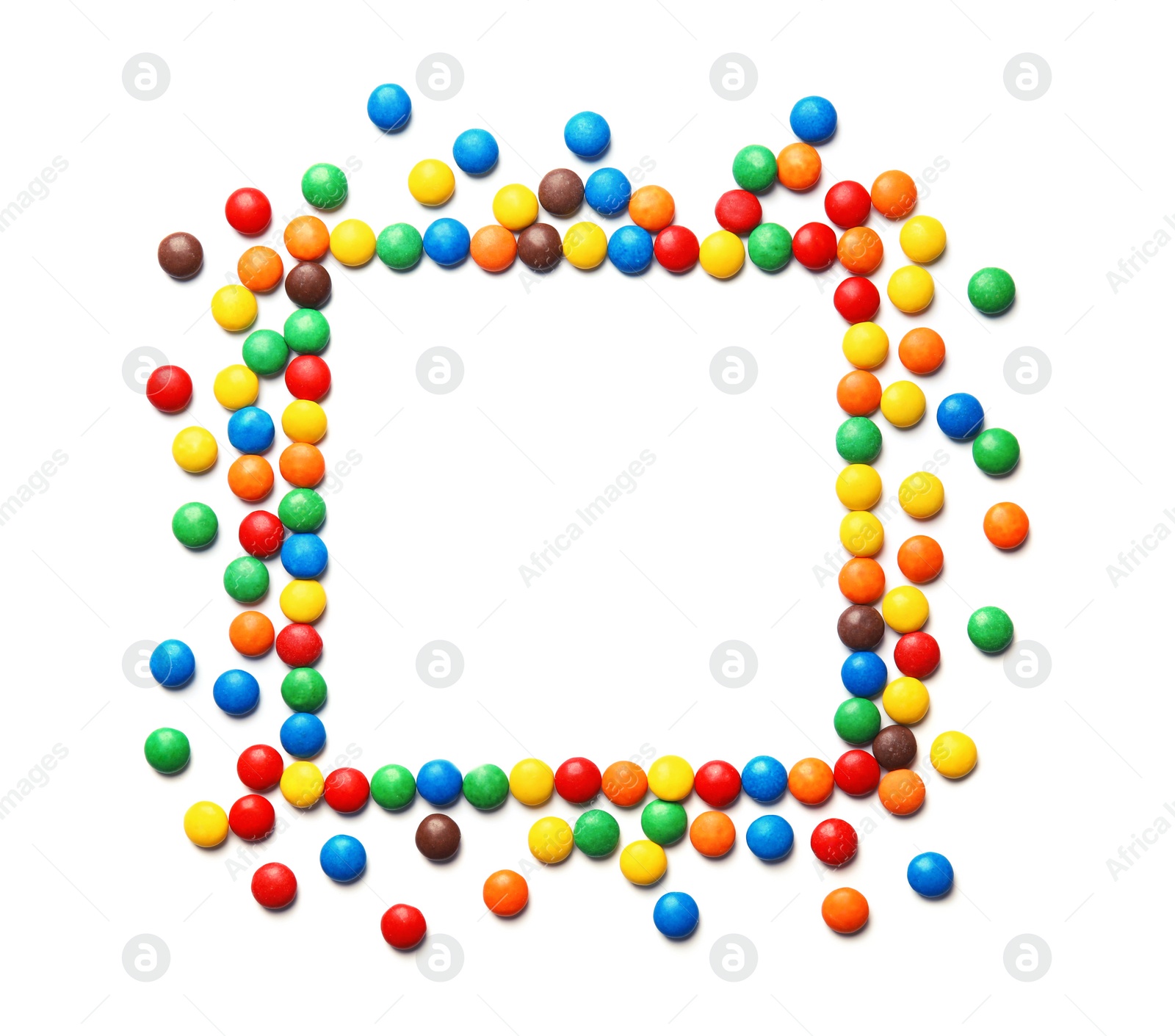 Photo of Frame made of colorful candies on white background, top view. Space for text