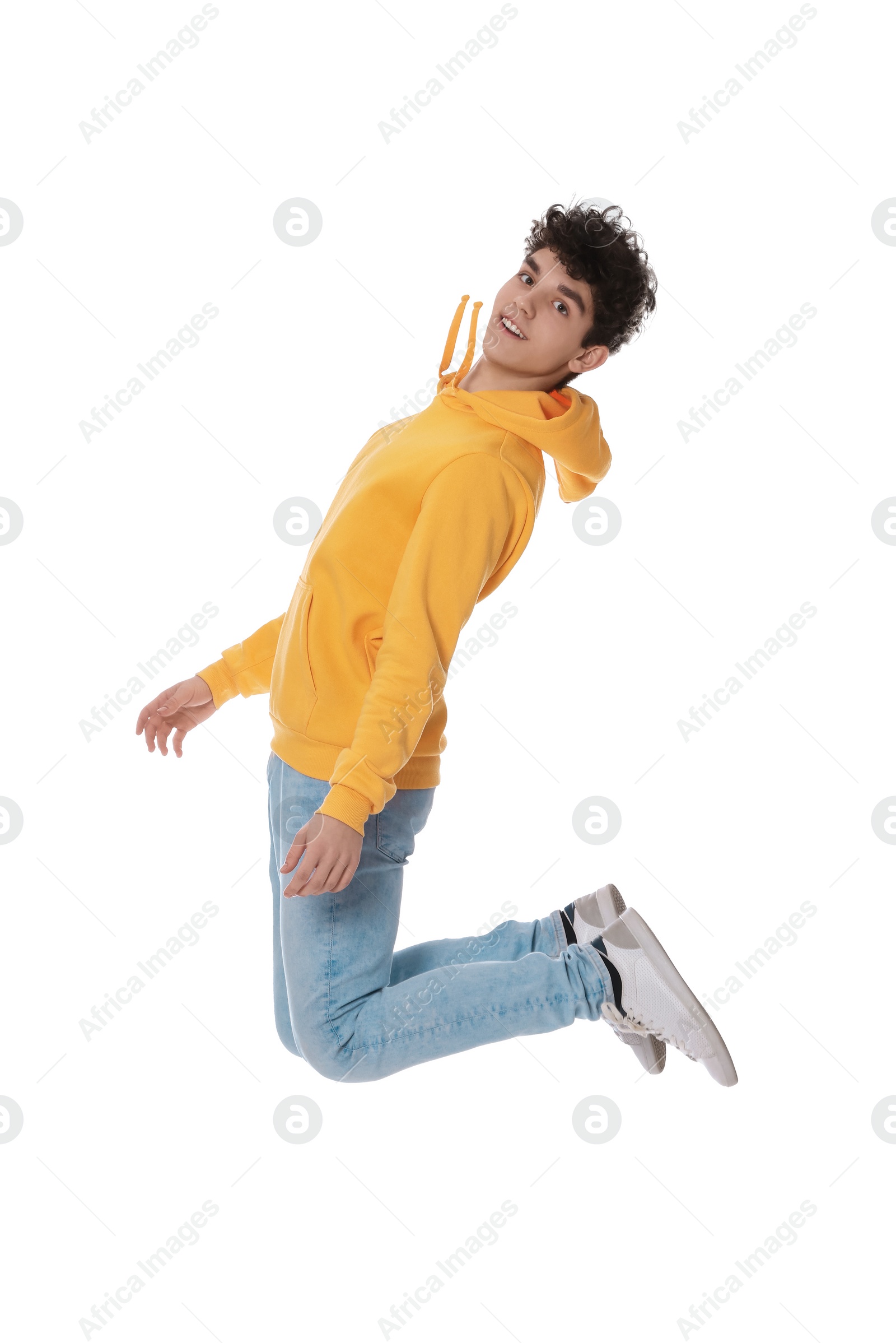 Photo of Happy teenage boy jumping on white background