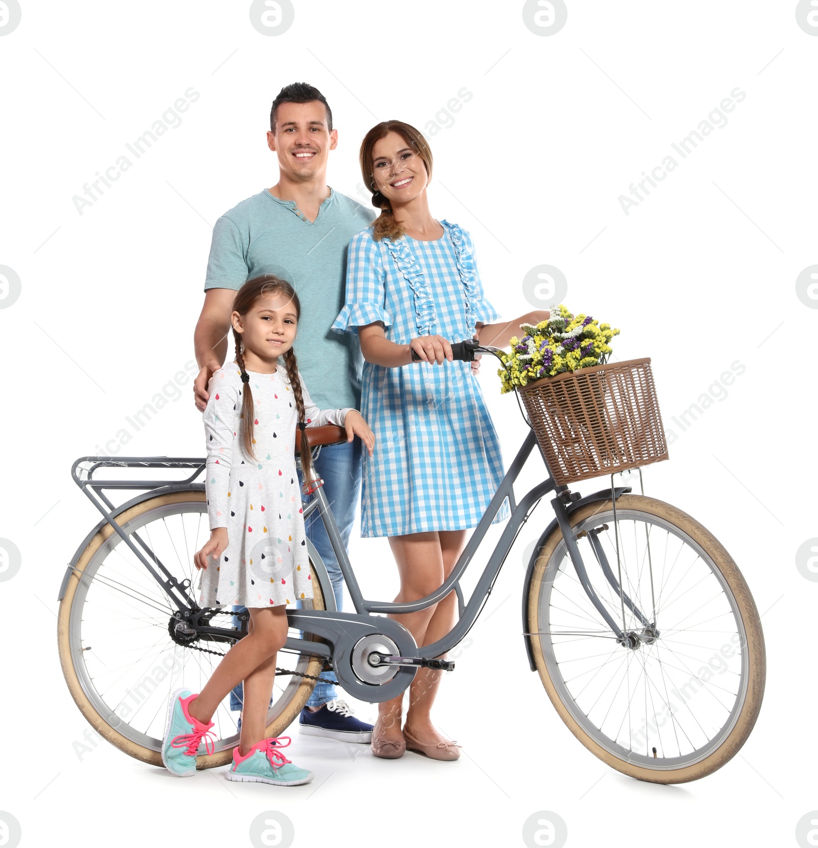 Photo of Portrait of parents and their daughter with bicycle on white background