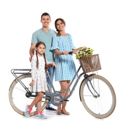 Portrait of parents and their daughter with bicycle on white background