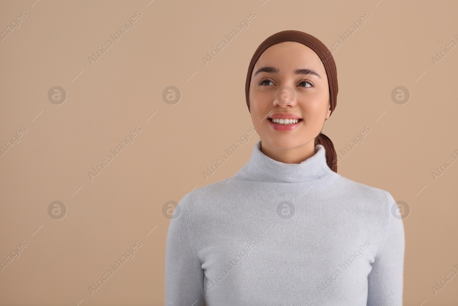 Photo of Smiling woman with cancer on beige background. Space for text