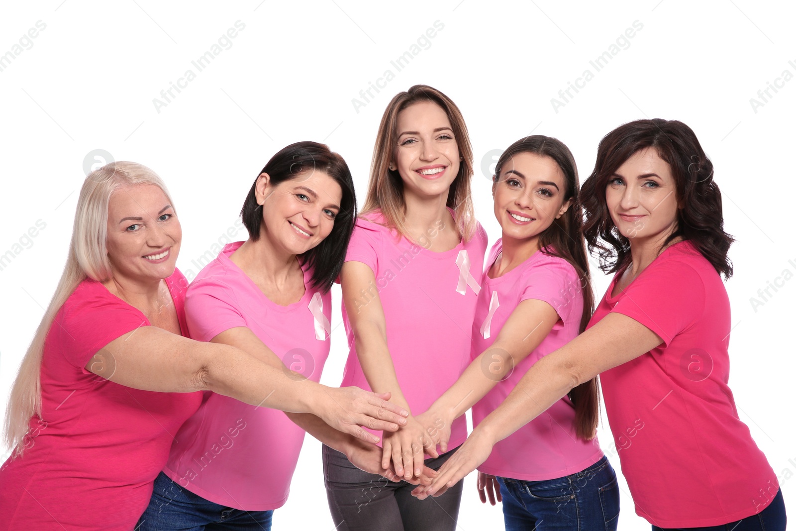 Photo of Group of women with silk ribbons joining hands on white background. Breast cancer awareness concept