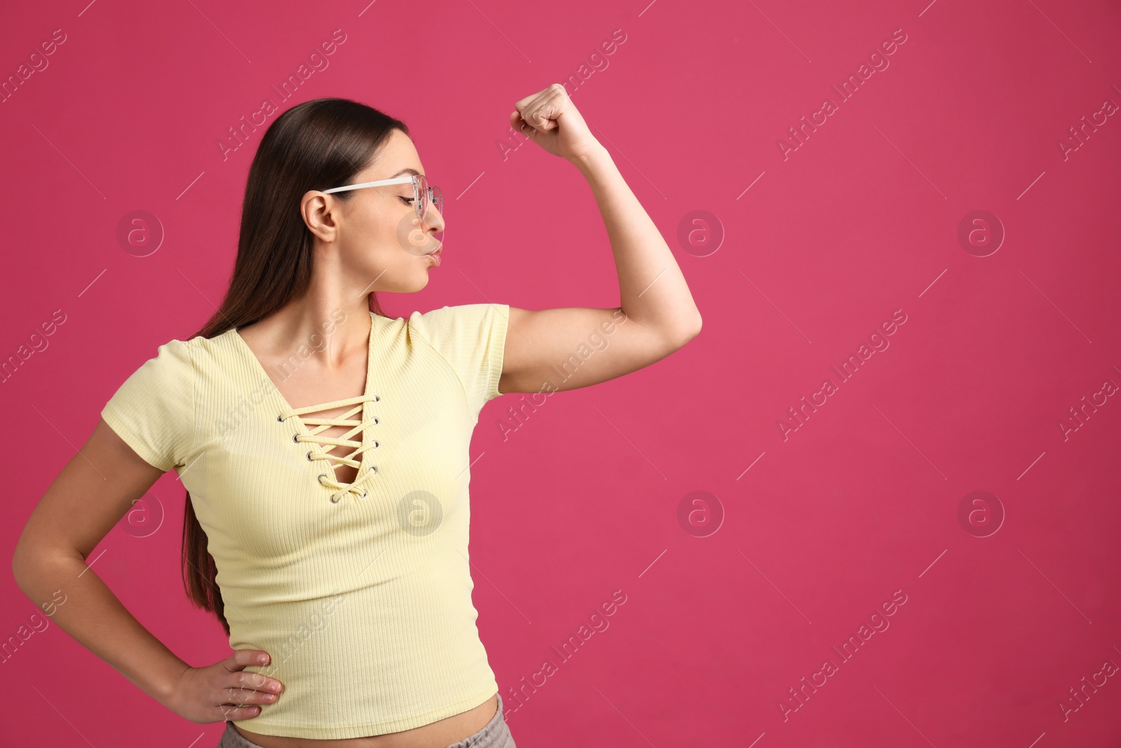 Photo of Strong woman as symbol of girl power on pink background, space for text. 8 March concept