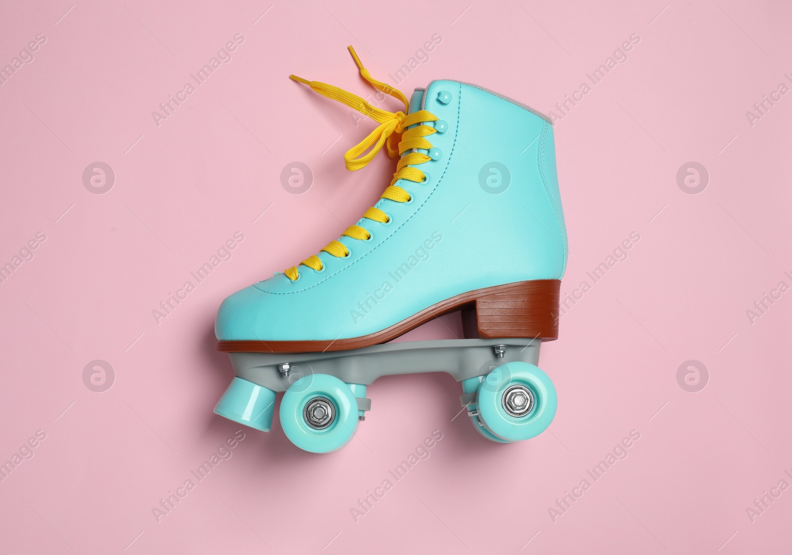 Photo of Stylish quad roller skate on color background, top view