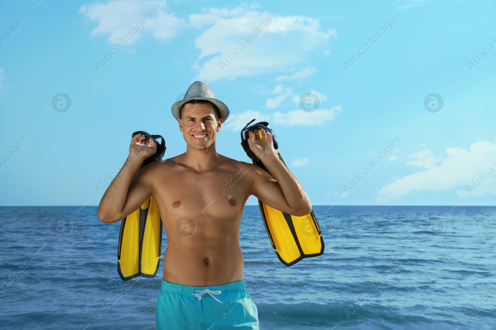 Photo of Happy man with flippers near sea on beach