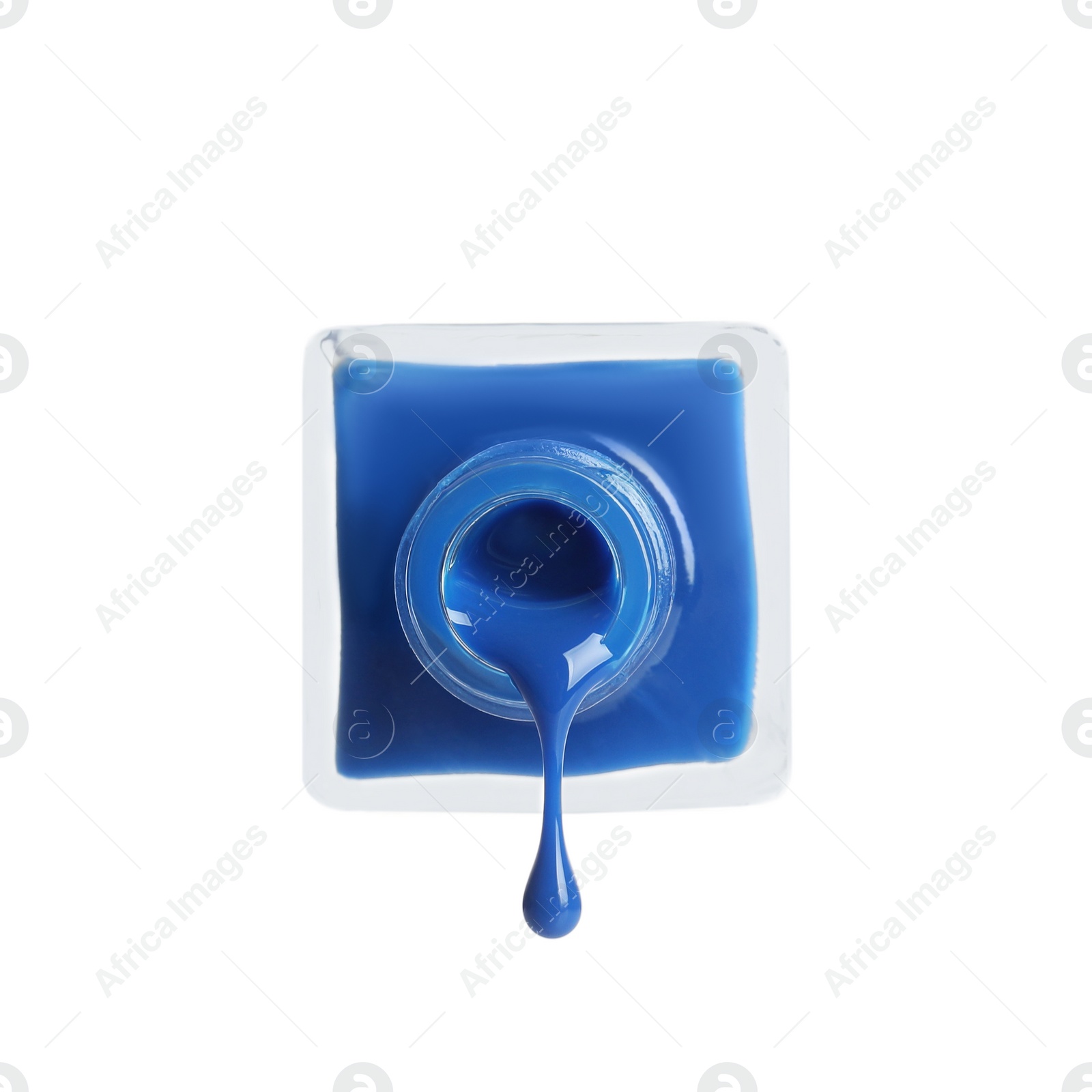 Photo of Pouring color nail polish from bottle on white background