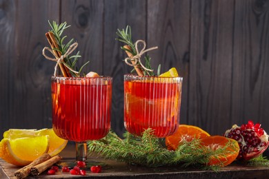 Christmas Sangria cocktail in glasses, ingredients and fir tree branches on table