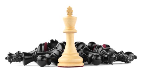 Photo of King among fallen chess pieces on white background