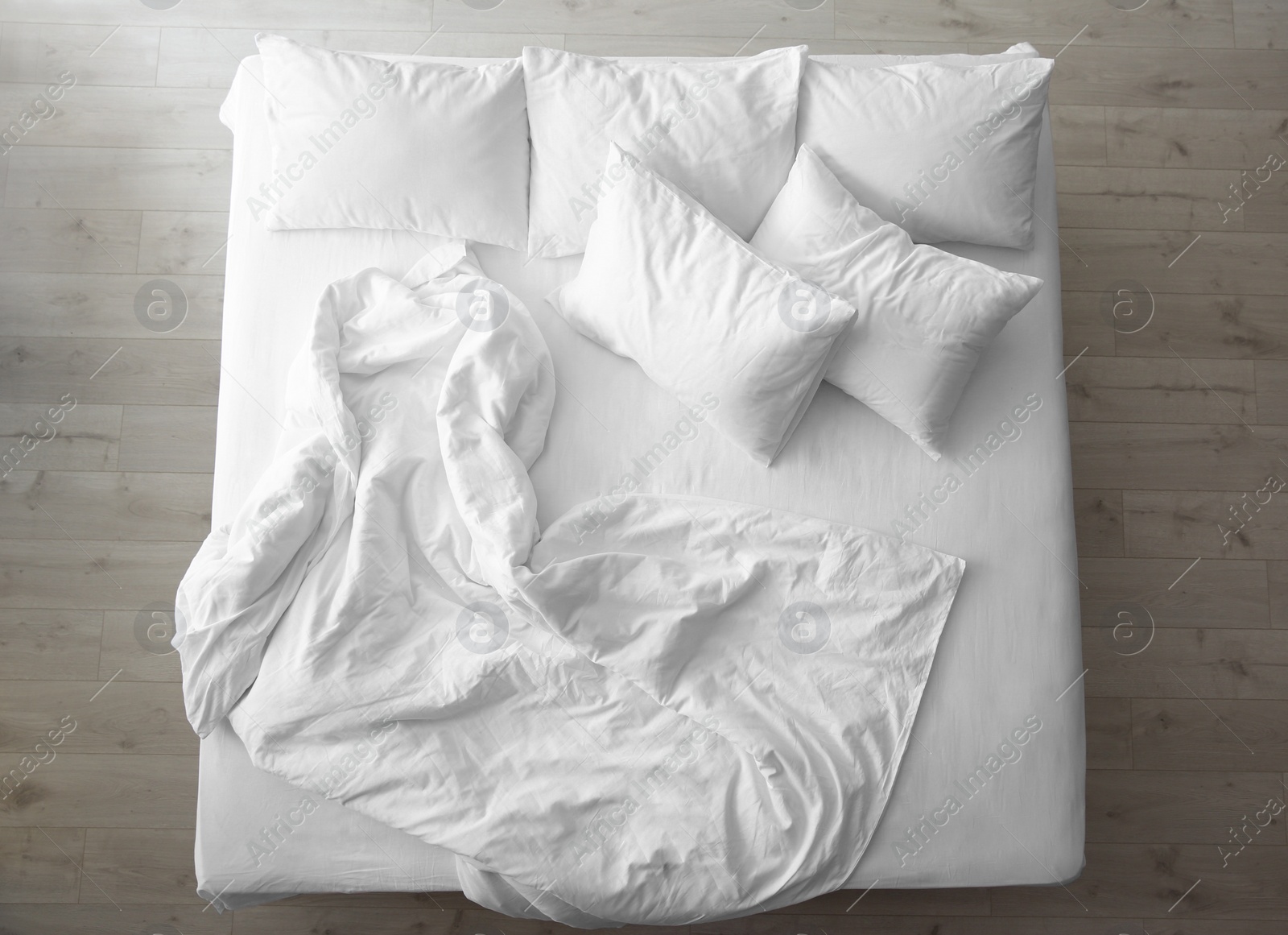 Photo of Comfortable bed with soft pillows indoors, top view