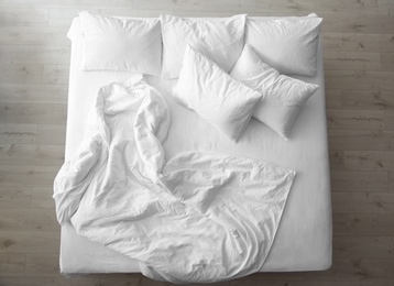 Comfortable bed with soft pillows indoors, top view