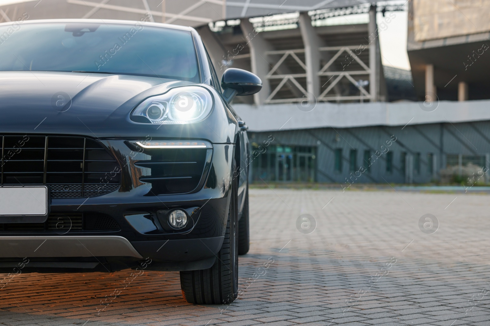 Photo of Modern black car parked outdoors, space for text