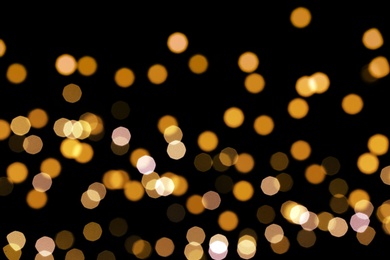 Beautiful golden lights on dark background. Bokeh effect