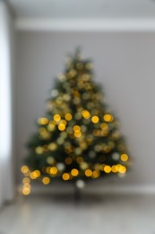 Photo of Blurred view of beautifully decorated Christmas tree indoors