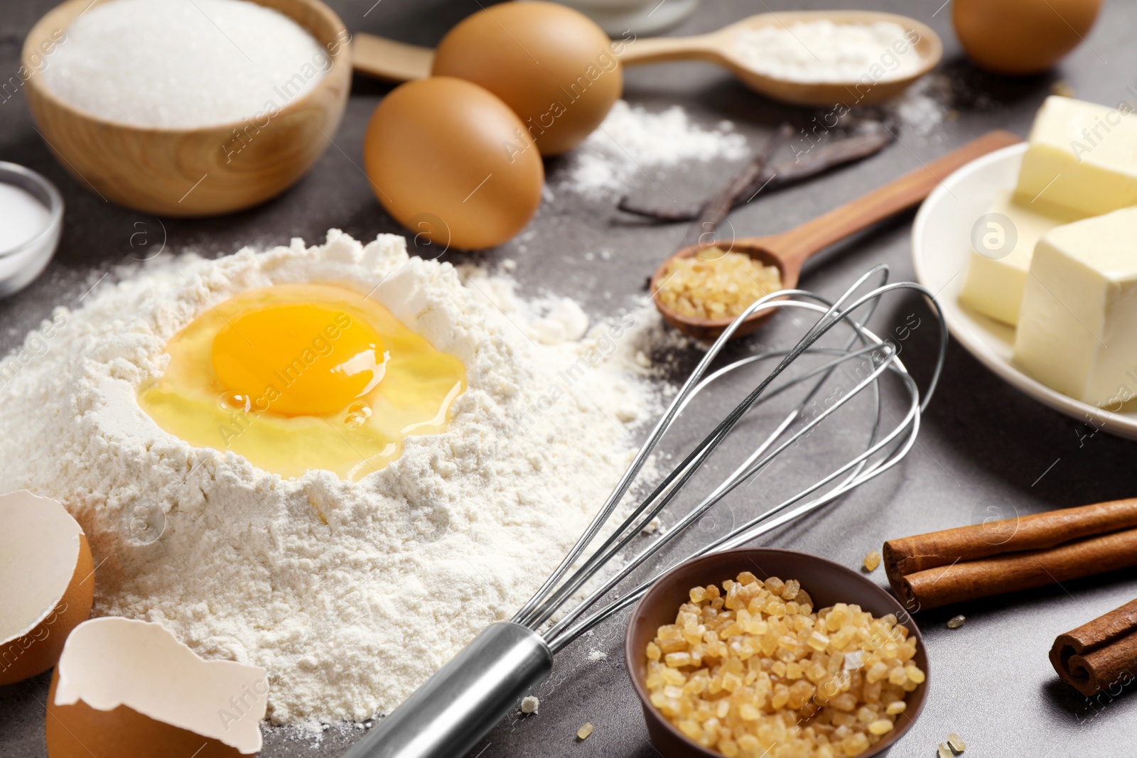 Photo of Fresh ingredients for delicious homemade cake on grey table