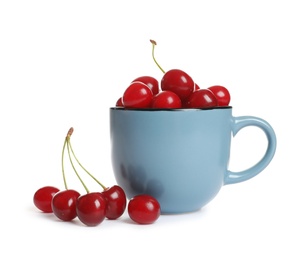 Light blue cup of delicious ripe sweet cherries on white background