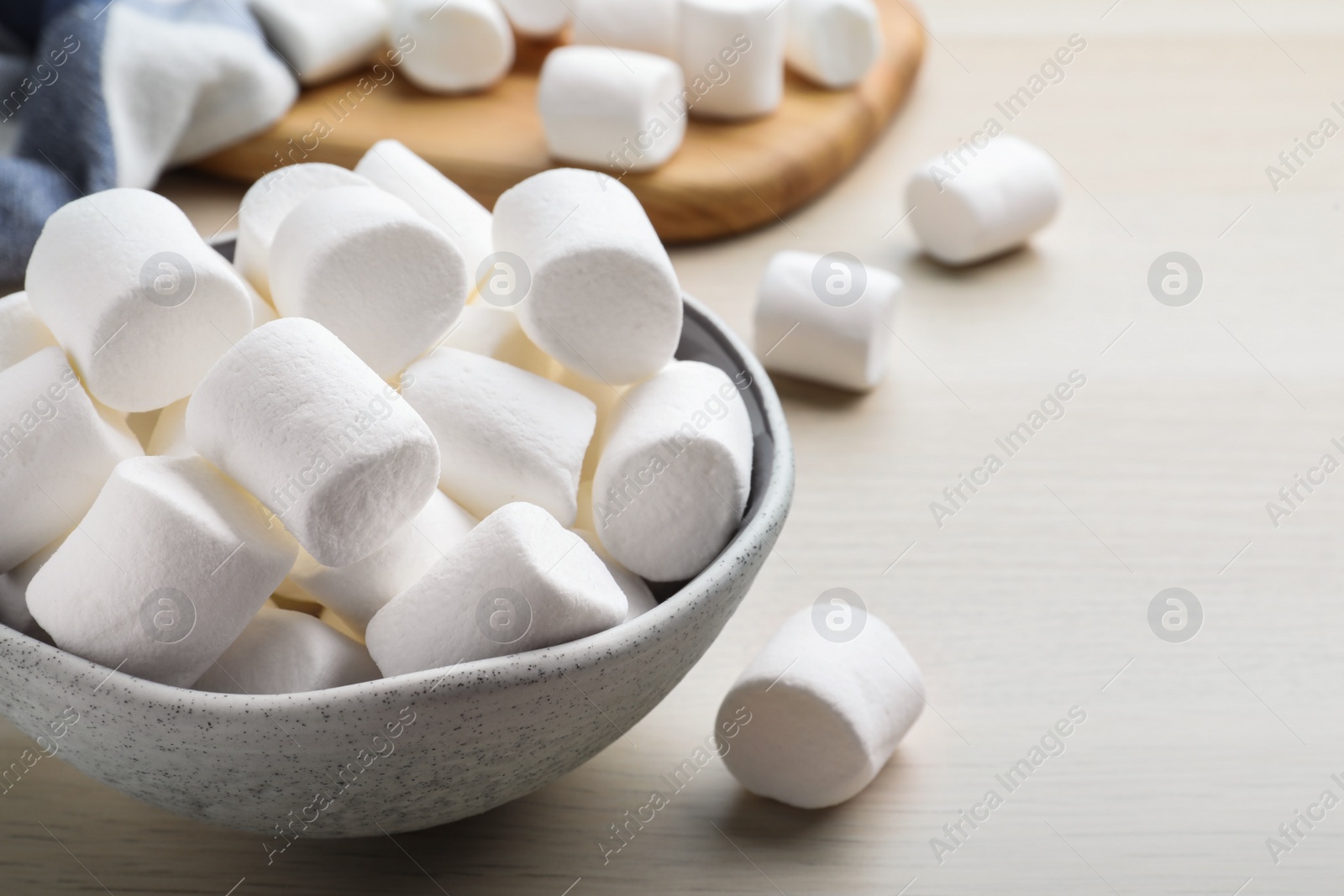 Photo of Delicious puffy marshmallows on wooden table, closeup