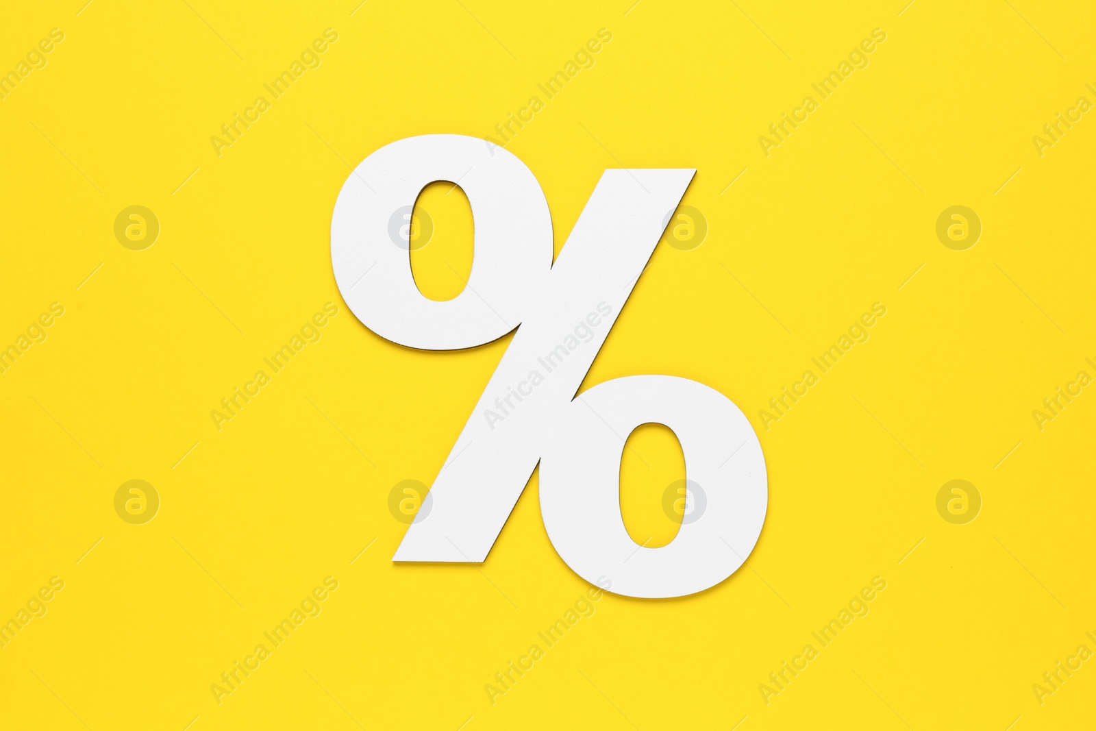 Photo of Paper percent symbol cutout on yellow background, top view