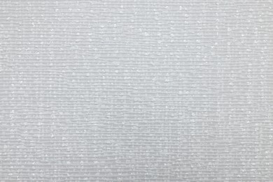 Stylish light grey wallpaper as background, closeup view