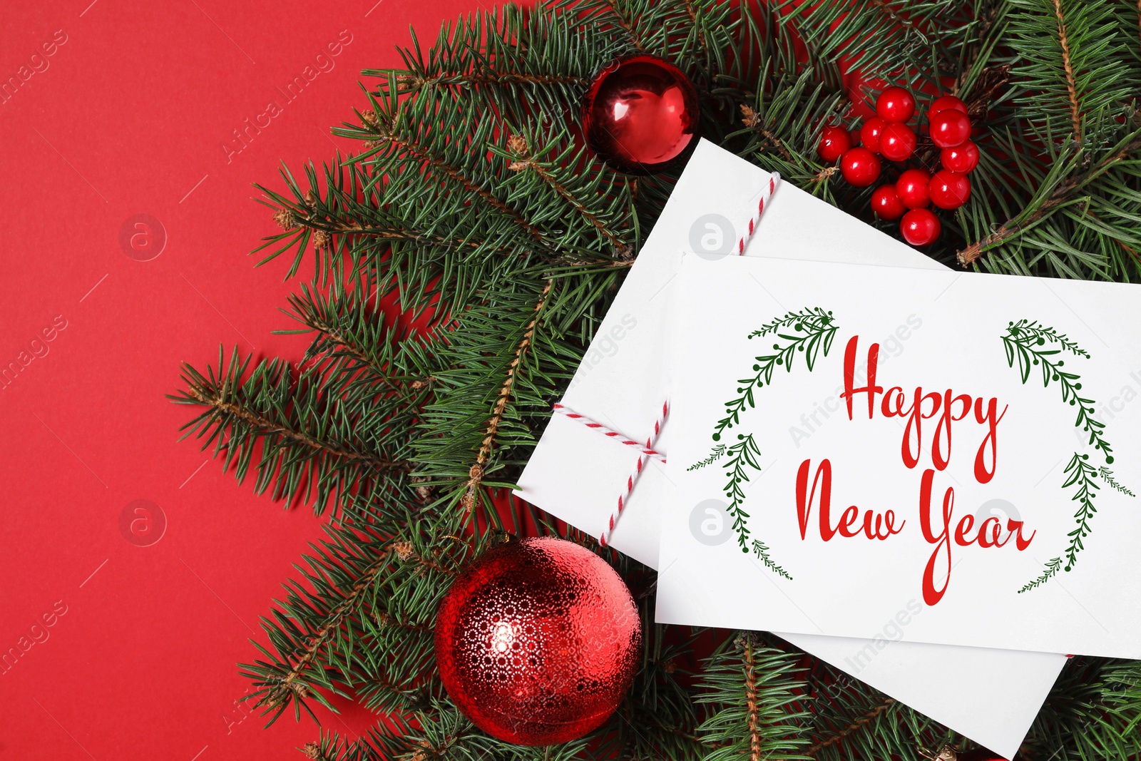 Image of Greeting card with text Happy New Year and Christmas decor on red background, flat lay