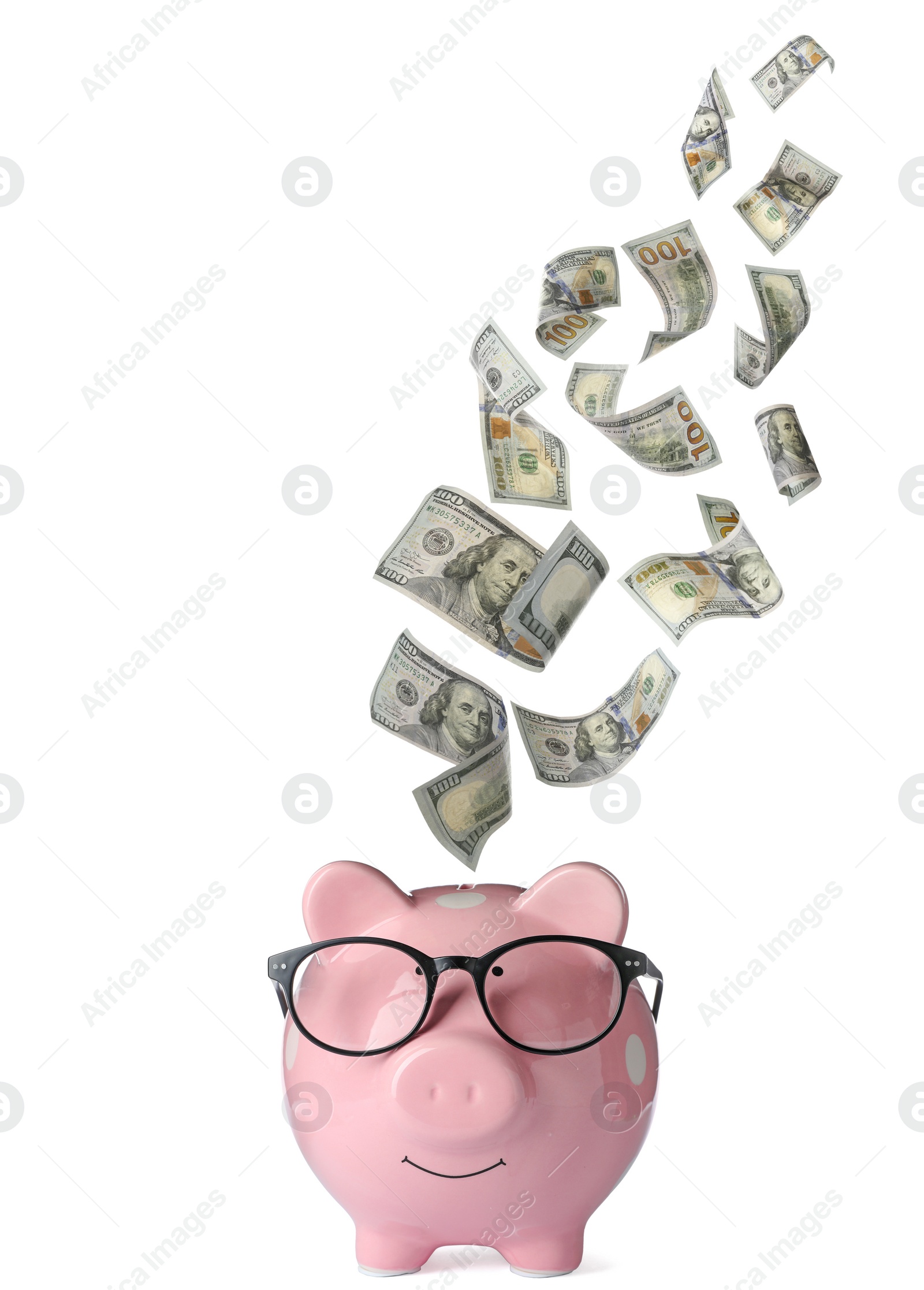 Image of Dollars falling into pink piggy bank on white background 