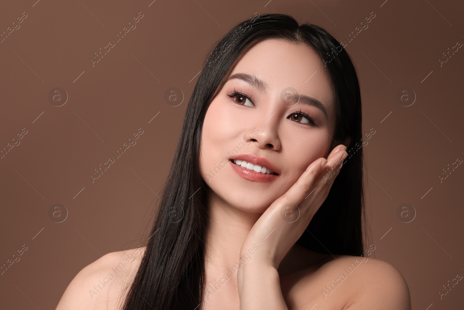 Photo of Portrait of beautiful woman on brown background