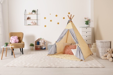 Cozy kids room interior with play tent and toys