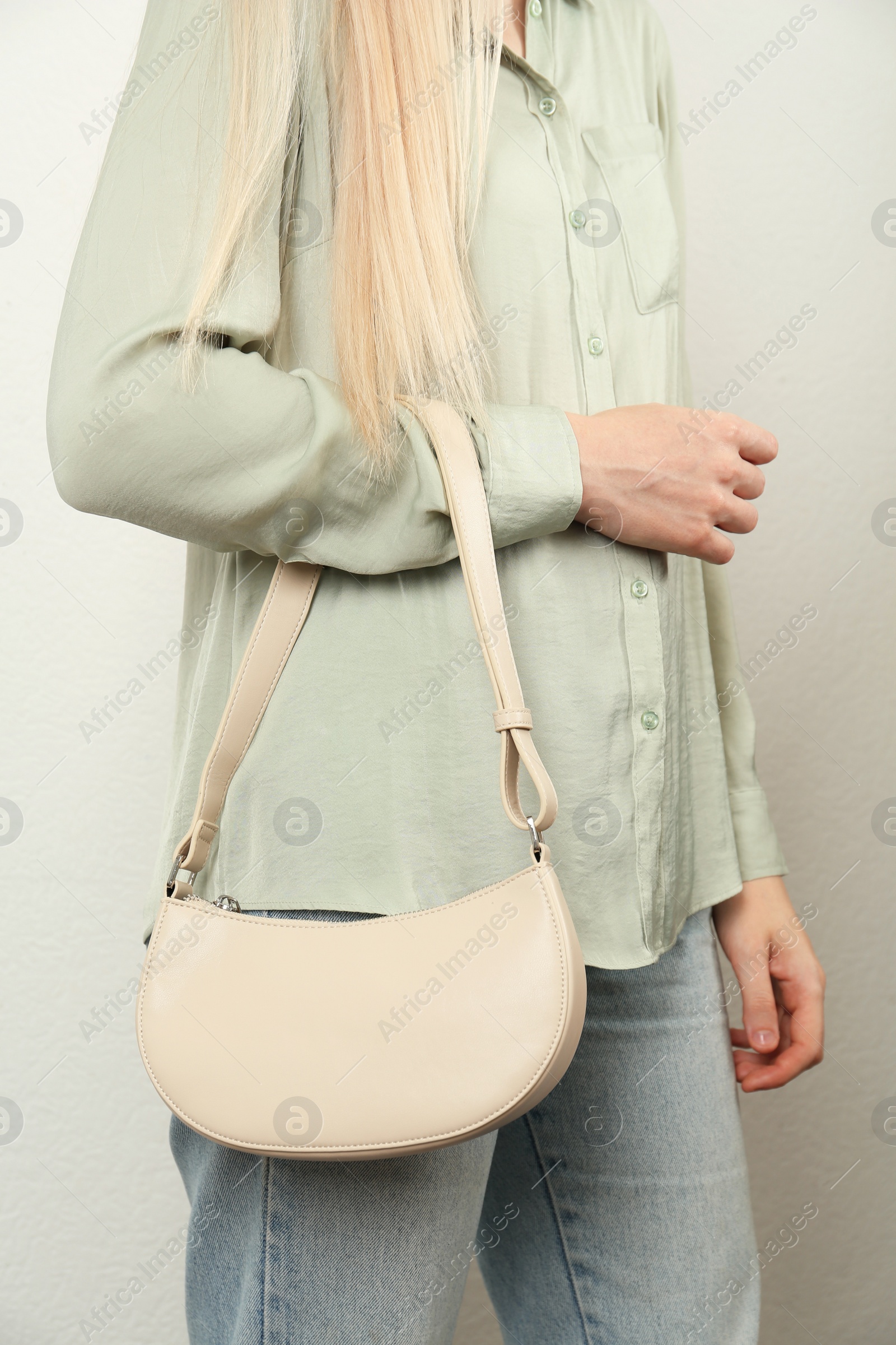 Photo of Woman with stylish baguette handbag on white background, closeup