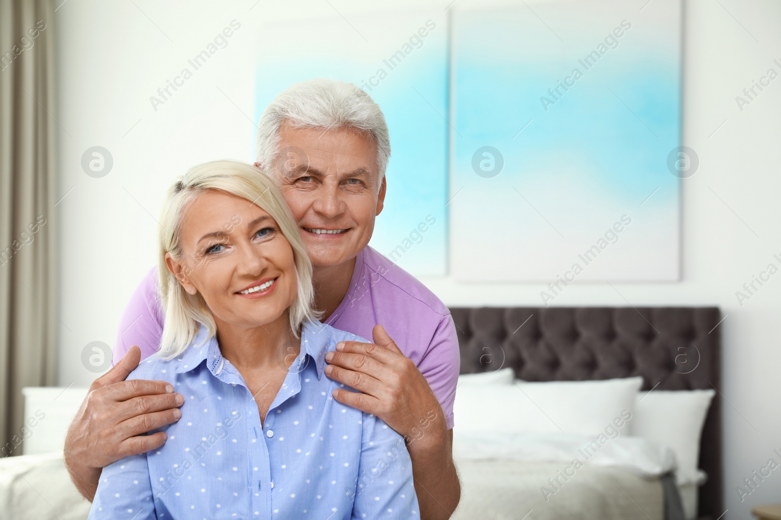 Photo of Portrait of happy senior couple at home. Space for text