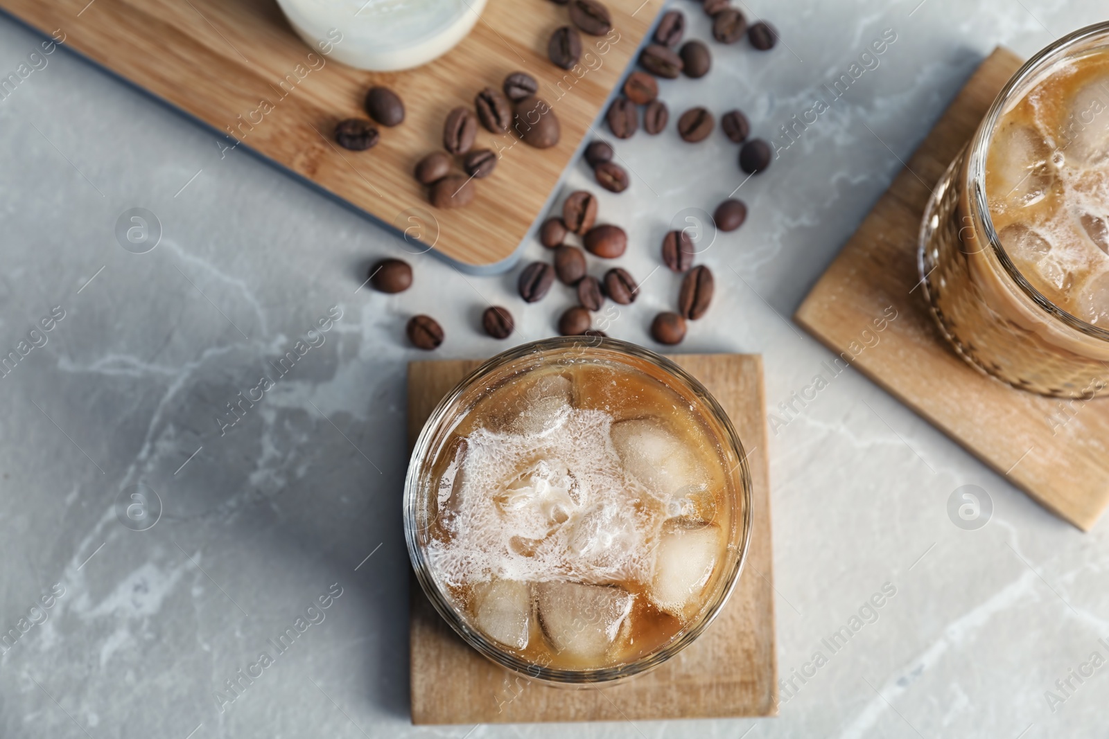 Photo of Glasses with cold brew coffee and milk on light background