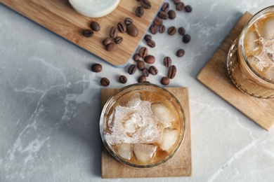 Glasses with cold brew coffee and milk on light background