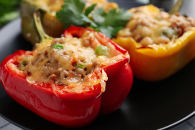 Photo of Tasty stuffed bell peppers on plate, closeup