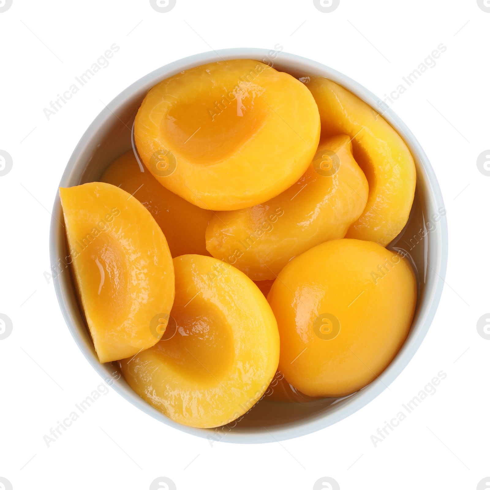 Photo of Halves of canned peaches in bowl isolated on white, top view