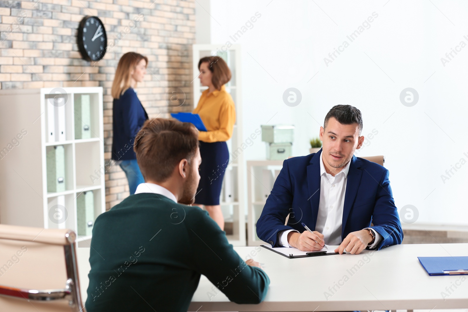 Photo of Human resources manager conducting job interview with applicant in office