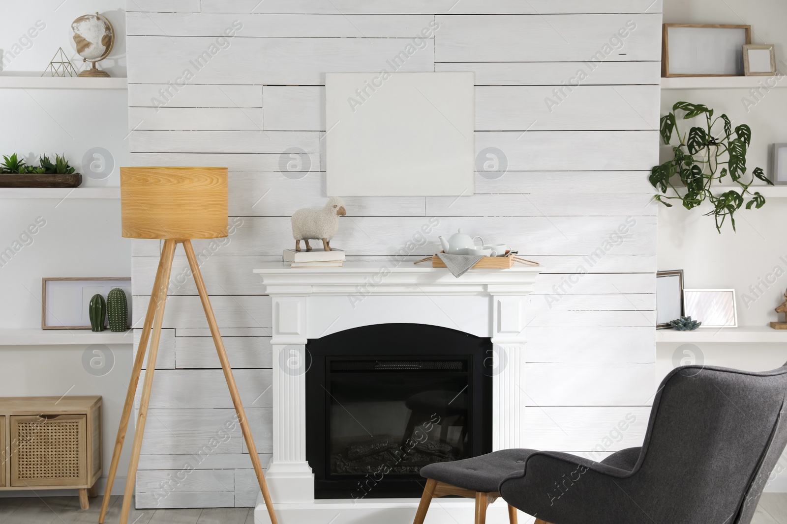 Photo of Stylish living room interior with empty canvas on white wooden wall. Mockup for design