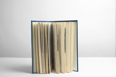 Photo of Open old hardcover book on white background