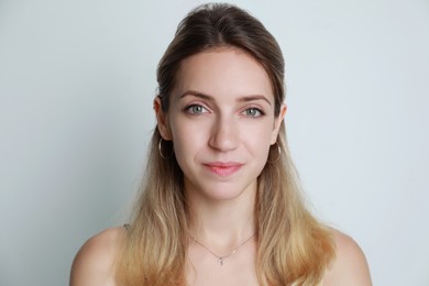 Portrait of beautiful woman on light background