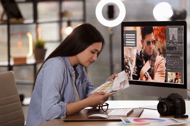 Photo of Professional retoucher working on computer in office