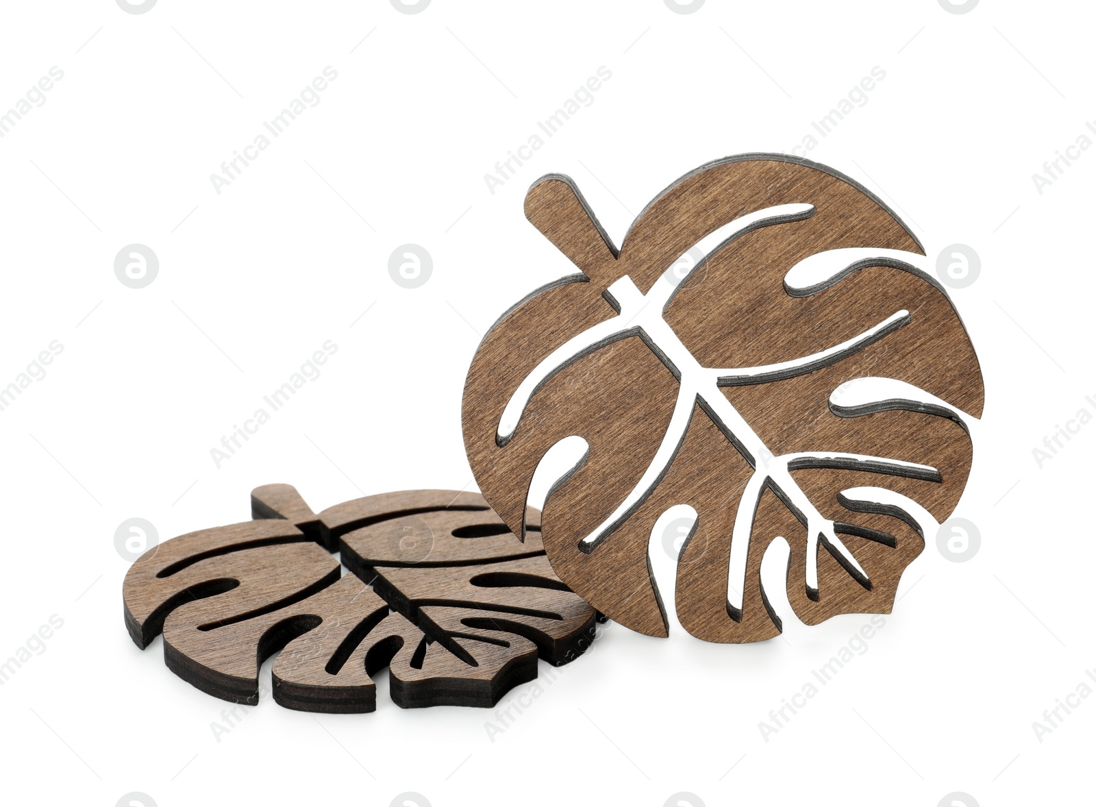 Photo of Leaf shaped wooden cup coasters on white background