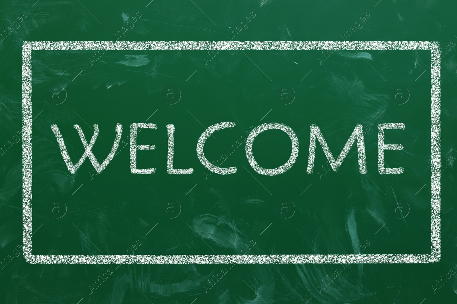 Image of Word WELCOME written on green chalkboard, top view