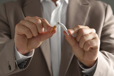 Stop smoking concept. Man breaking cigarette, closeup