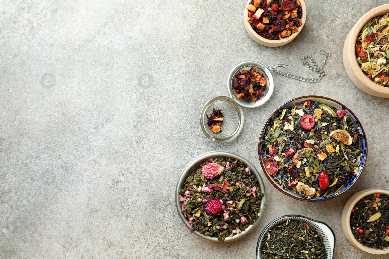 Photo of Many different herbal teas on grey table, flat lay. Space for text