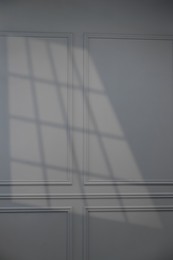 Shadow from window on grey wall indoors